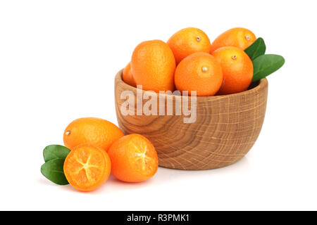 Cumquat or kumquat with leaf in wooden bowl isolated on white background close up Stock Photo