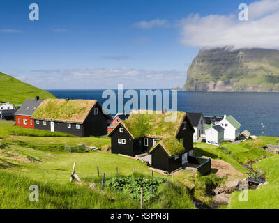 Village Mikladalur, on the Island Kalsoy, in background the island Kunoy. Faroe Islands, Denmark Stock Photo