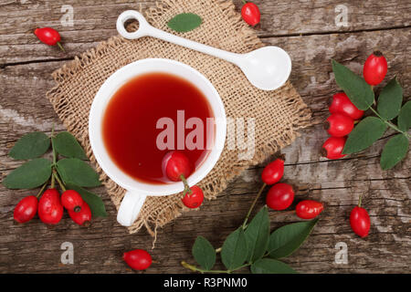 tea with rose hips on old wooden background. Top view Stock Photo