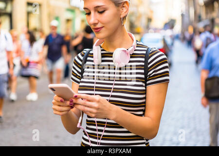 Woman using smartphone on the street Stock Photo