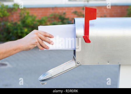 Person Removing Letters From Mailbox Stock Photo