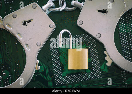 Digital security concept: Open lock with handcuffs on the background of a computer chip Stock Photo