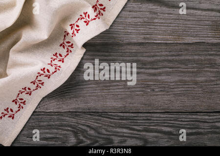 Top view of gray napkin on the left side of wooden table with copy space Stock Photo