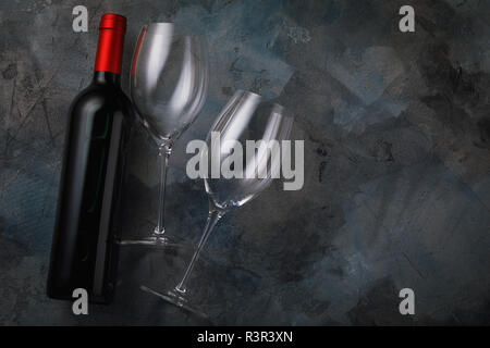 Two empty glasses and a bottle of red wine on table with copy space Stock Photo