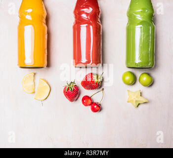 Variety of colorful Smoothies or juices bottles beverages drinks with various fresh ingredients: fruits ,berries Place for text Stock Photo