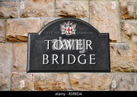 Tower Bridge sign in London in the background a sandstone wall Stock Photo