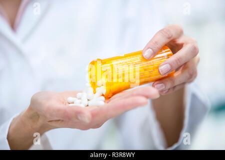 Pouring pills into hand. Stock Photo