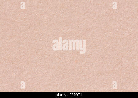 Recycled craft paper textured background in light pink old rose color. Stock Photo