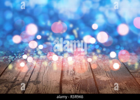Abstract christmas light bokeh on wooden background Stock Photo