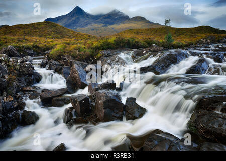 United Kingdom, Scotland, Scottish Highlands, Isle Of Skye, Waterfall at Sligachan river with view to the Cuillin mountains Stock Photo