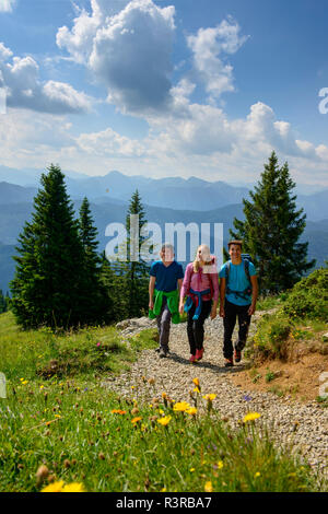 Germany, Bavaria, Brauneck near Lenggries, young friends hiking in alpine landscape