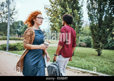 Man and woman going to work, passing each other Stock Photo