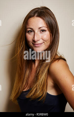 Portrait of smiling young woman with freckles Stock Photo