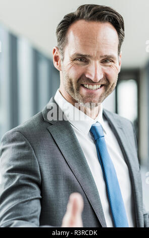 Portrait of smiling businessman shaking hands Stock Photo