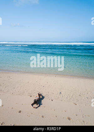 top aerial view of a woman lying on a tropical beach sand Stock Photo ...