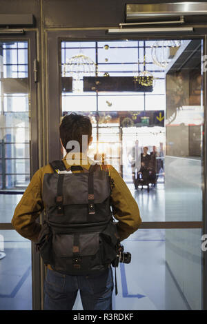 Young man with backpack standing at the airport Stock Photo