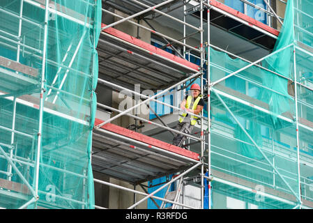 Miedzyzdroje, Poland, September 27, 2018: A smiling worker on scaffolding. Stock Photo