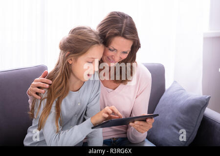 Close-up Of Mature Mother With Her Daughter Surfing On Internet With Digital Tablet Stock Photo