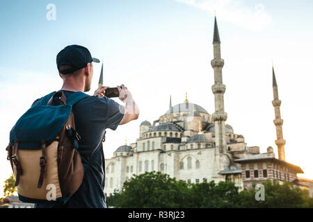 Tourist photographs the Blue Mosque in Istanbul in Turkey for memory. Stock Photo