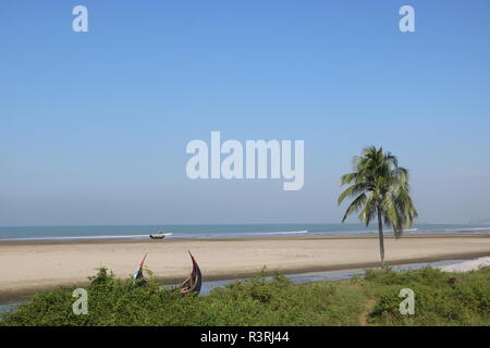 Scenery of green nature with blue water and blue sky at cox's bazar sea beach in Bangladesh. Stock Photo