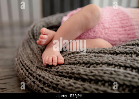 the mother's hand holds legs. Stock Photo