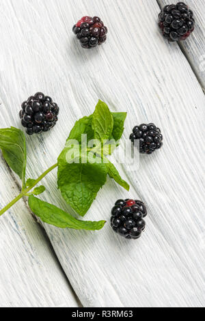 Blackberries on a old white painted wooden background. Stock Photo