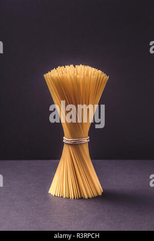spaghetti in bunch on black background Stock Photo