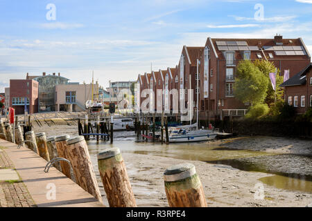 inner harbor at low tide in the old town of Husum on a sunny day, north sea coast in germany, selected focus Stock Photo