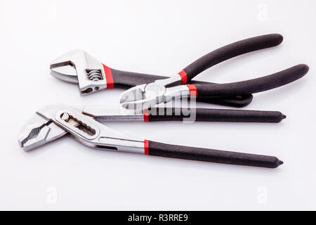 Tongs, tongs with flat, clammy ends on a white background. Long nasal and diagonal cutters. With black rubber on the handle, it becomes more comfortab Stock Photo