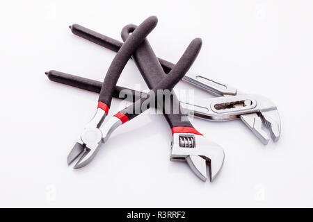 Tongs, tongs with flat, clammy ends on a white background. Long nasal and diagonal cutters. With black rubber on the handle, it becomes more comfortab Stock Photo