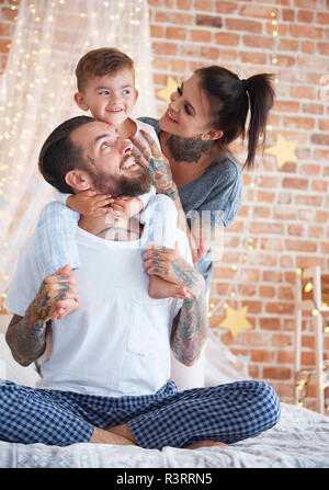 Happy family at Christmas time in bed Stock Photo