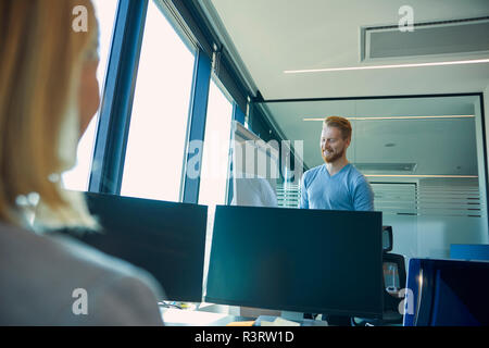 Smiling man at flip chart in office Stock Photo