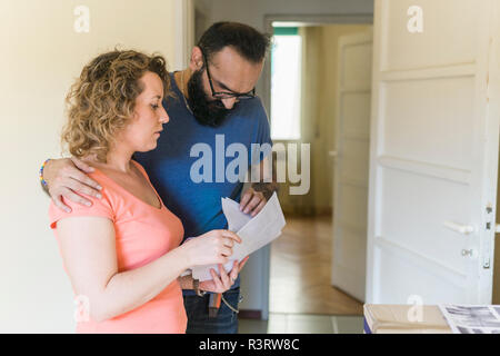 Couple examining contract of new home Stock Photo