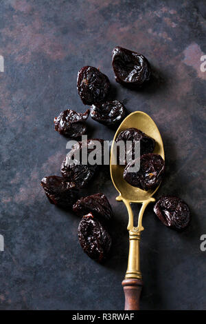 Prunes on a vintage brass spoon Stock Photo