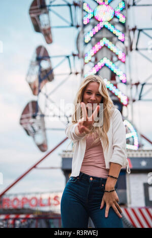 Portrait of smiling young woman on a funfair Stock Photo