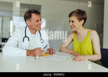 Woman discussing teatment with her doctor Stock Photo