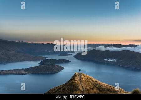 New Zealand, South Island, Wanaka, Otago, Woman on Coromandel peak at sunrise Stock Photo
