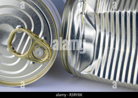 Can with meat dish on a white table. Canned food with a long shelf life. Light background. Stock Photo