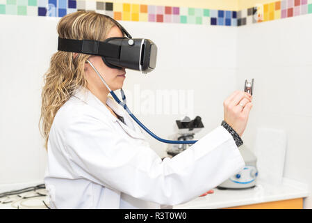 Female doctor wearing virtual reality glasses. Medical technology concept Stock Photo