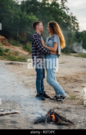 Romantic couple at the riverside, falling in love Stock Photo
