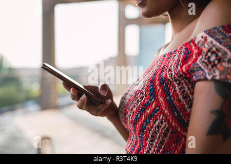 Woman using cell phone, partial view Stock Photo