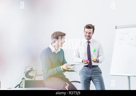 Two smiling colleagues working on project in office Stock Photo