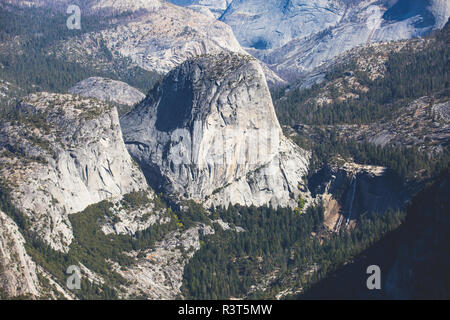 Panoramic summer view of Yosemite valley with Half Dome mountain, Tenaya Canyon, Liberty Cap, Vernal Fall and Nevada Fall, seen from Glacier point ove Stock Photo