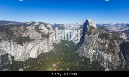 Panoramic summer view of Yosemite valley with Half Dome mountain, Tenaya Canyon, Liberty Cap, Vernal Fall and Nevada Fall, seen from Glacier point ove Stock Photo