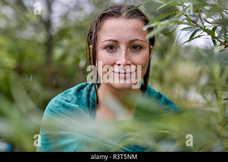 Portrait of woman with wet hair wrapped in a towel in nature Stock ...