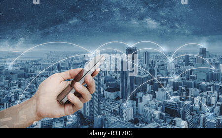 Hand using mobile smart phone, and network connection technology in the city. Business networking and internet connection Stock Photo