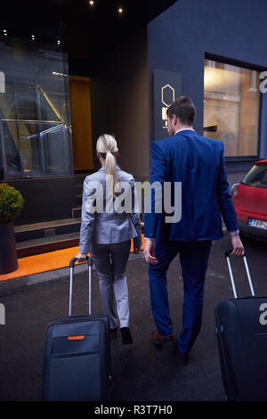 business people couple entering  hotel Stock Photo