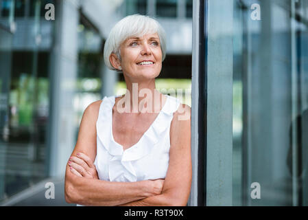 Portrait of smiling senior woman looking sideways Stock Photo