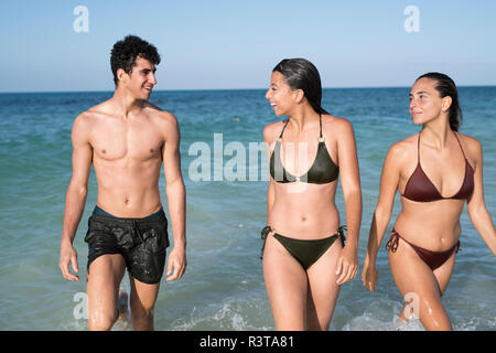 Happy friends walking in the sea Stock Photo