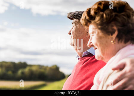 Senior couple embracing in rural landscape Stock Photo
